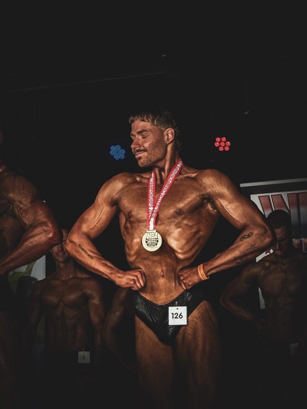 VS.Coaching-Athlet mit Goldmedaille auf der Bühne